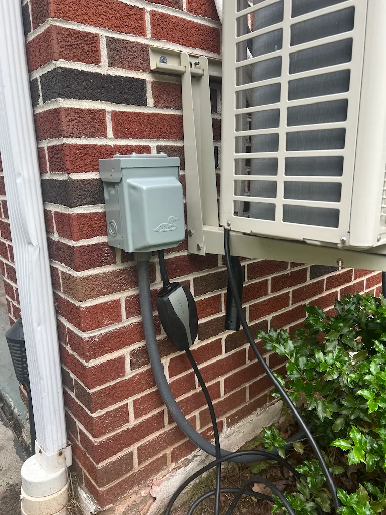 Outdoor disconnect and EV charger installation on a brick home