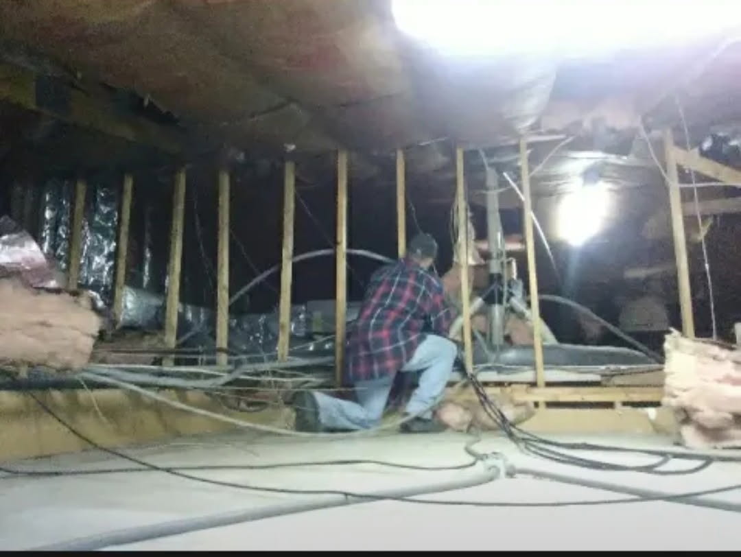 Electrician running wire in a restaurant crawl space in 2018