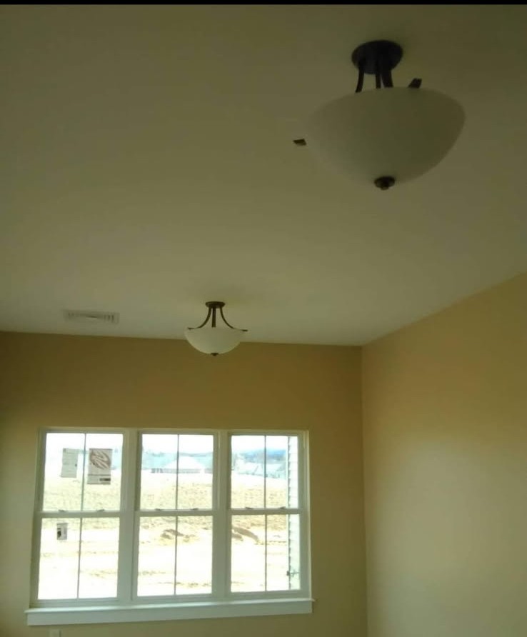 Two new ceiling light fixtures installed in a freshly painted room