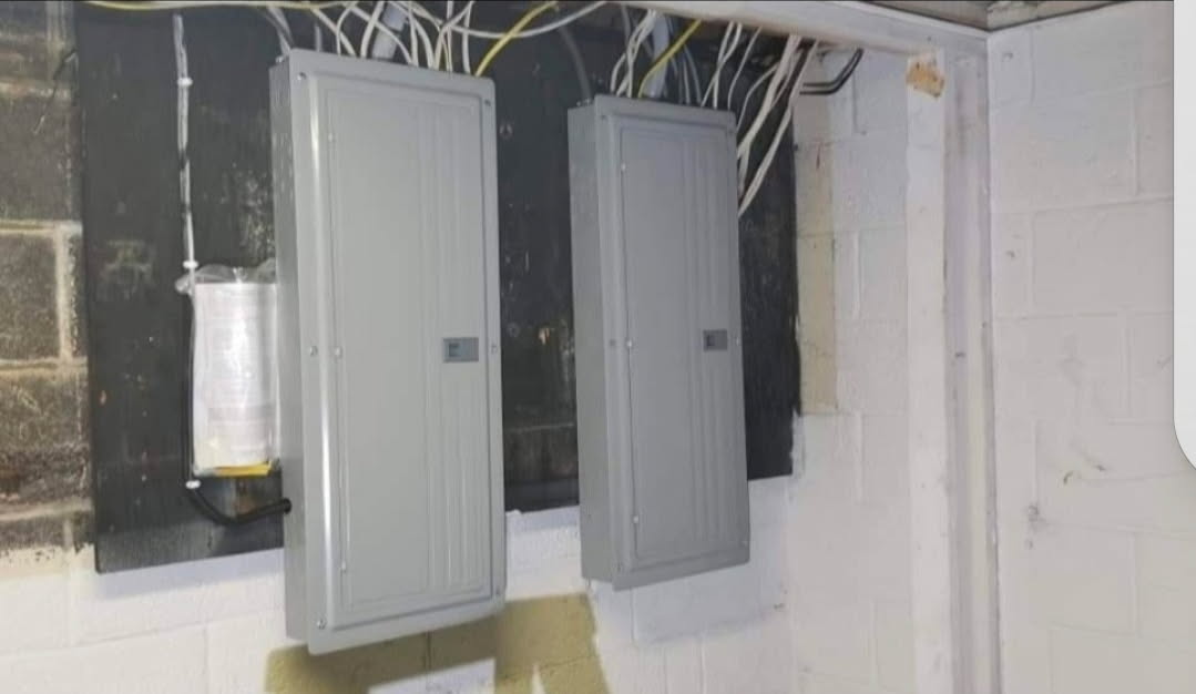 Two new electrical panels neatly installed after old equipment removal