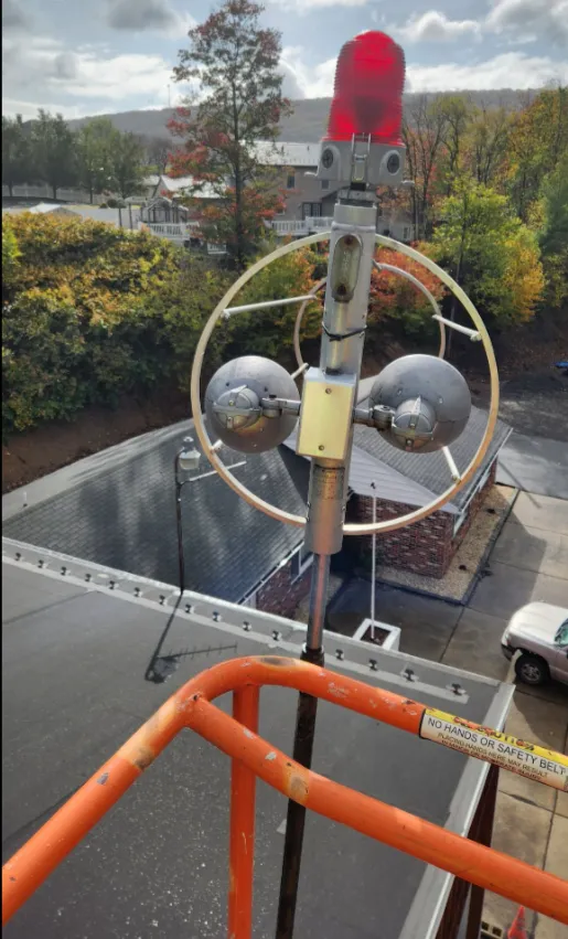 Old rooftop helicopter wind sock and mast before replacement